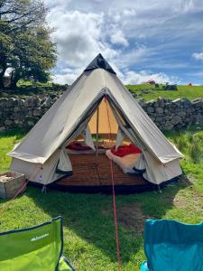 a tent is set up in a field at Wild Camping Teepee in Capel Curig +23 photos