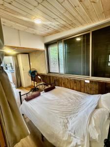 a large bed in a room with a window at Tzimmer B'Kfar הצימר בכפר in Kefar Pines +14 photos