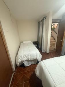 a room with two beds and a staircase in it at Hotel boutique Blanca Gazza in Arica