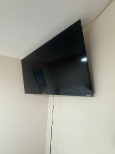 a flat screen tv hanging on a white wall at Hotel boutique Blanca Gazza in Arica