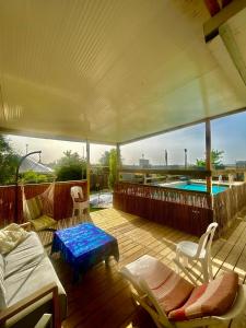 a deck with a bed and a swimming pool at Tzimmer B'Kfar הצימר בכפר in Kefar Pines