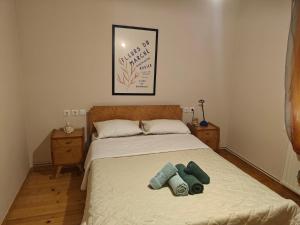 a bedroom with a bed with two towels on it at Harys Home in Korinos