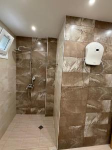 a shower with a glass door in a bathroom at Water House in Shumen +7 photos