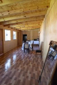 a large room with a table and chairs in it at Hostal Urenda in Los Ángeles