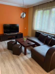 a living room with a couch and a table at Water House in Shumen