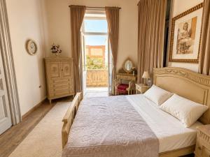 a bedroom with a large bed and a large window at 7 Heaven in Alexandria