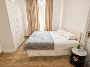 a small bedroom with a bed and a window at 7 Heaven in Alexandria