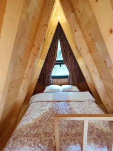 a bedroom with a bed in a attic at Zvezdana šuma in Žabljak