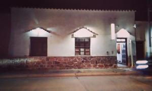 a building with two windows and a brick wall at maimareña in Maimará