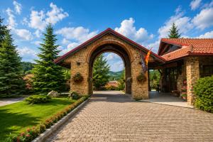 an entrance to a house with an archway at Aurora Resort & Spa in Berovo