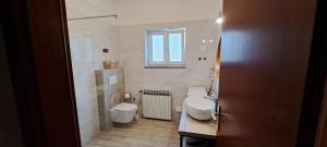 a bathroom with a toilet and a sink and a window at Apartments Desiree & Daniel in Dramalj +32 photos