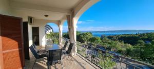a balcony of a house with a view of the ocean at Apartments Desiree & Daniel in Dramalj