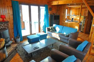 a living room with a couch and a table at Arbre Dressé in Somme-Leuze