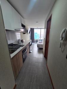 a room with a kitchen and a living room at PENINSULA DE CAVANCHA, Vista ESPECTACULAR in Iquique +3 photos