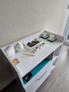 a white cabinet with dishes and chopsticks on it at PENINSULA DE CAVANCHA, Vista ESPECTACULAR in Iquique