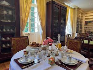 a dining room table with a white table cloth and glasses at Château de Puchesse in Sandillon