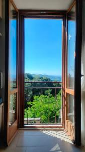 a room with a large window with a view at Ciliano 16 in Montepulciano