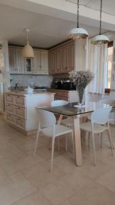 a kitchen with a table and some chairs and a table and a kitchen at Ciliano 16 in Montepulciano