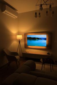 a living room with a flat screen tv on a wall at Green Hill Villa in Tirana