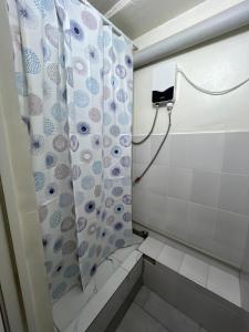 a bathroom with a shower with a shower curtain at Global Hostel in Almaty