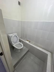a bathroom with a toilet with the seat up at Global Hostel in Almaty