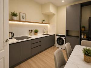 a kitchen with a sink and a washing machine at Global Hostel in Almaty