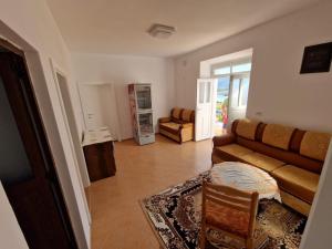 a living room with a couch and a table at Bujtina Dalmacia in Shkodër