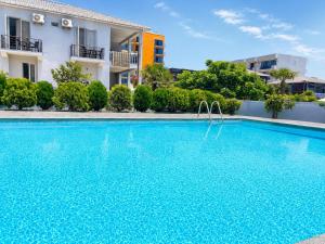 a large blue swimming pool in front of a building at Hotel Arev Kobuleti in Kobuleti