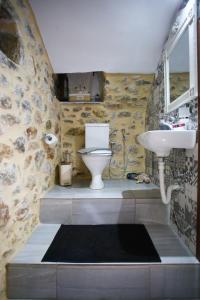 a bathroom with a toilet and a sink at Stratis Tower Since 1892 in Oitylo +59 photos