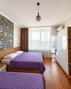 a hotel room with two beds and a window at Hotel Arev Kobuleti in Kobuleti +5 photos