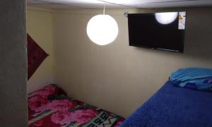 a bedroom with a bed and a flat screen tv at maimareña in Maimará
