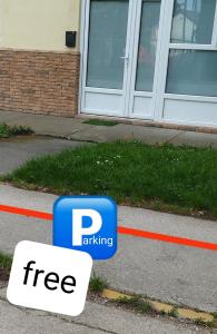 a free parking sign on the side of a street at Apartman Nevena in Subotica