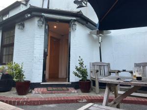 a house with a wooden door and a wooden bench at Plough inn in Great Mongeham +23 photos