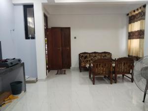 a living room with a couch and a table at Jayasiri Riverfront Home in Lansiyawatta +3 photos