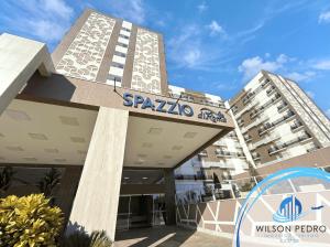 a building with a sign that reads spaja apartment at Spazzio diRoma in Caldas Novas