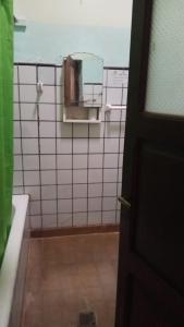 a bathroom with a mirror on a tiled wall at maimareña in Maimará