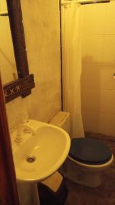 a bathroom with a white sink and a toilet at maimareña in Maimará +4 photos