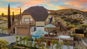a house in the desert with a roof at Rockaway Mesa Dome Views Pool Karaoke Sauna in Yucca Valley