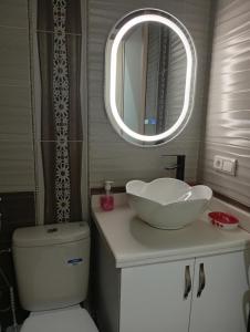 a bathroom with a sink and a toilet and a mirror at Cozy and Comfortable Apartment in Agadir +21 photos