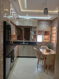 a kitchen with a table and a dining room at Cozy and Comfortable Apartment in Agadir