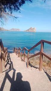 a shadow of a person taking a picture of the ocean at Casa chispa in Águilas