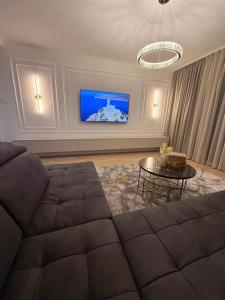 a living room with a couch and a tv at NOIR Luxury in Trebinje