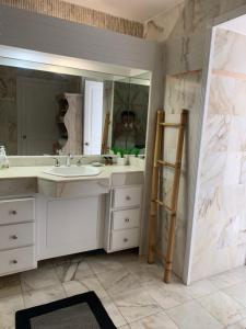 a bathroom with a sink and a mirror at Seabreeze suite in Cupe Coy +34 photos