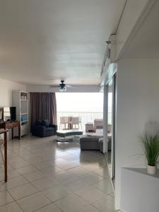 a living room with a couch and a table at Seabreeze suite in Cupe Coy