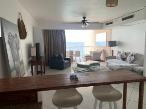 a living room with a table and a couch at Seabreeze suite in Cupe Coy