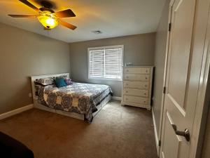 a bedroom with a bed and a ceiling fan at Lake Life Adventures 4 Bedroom Home in Lake Harmony +23 photos