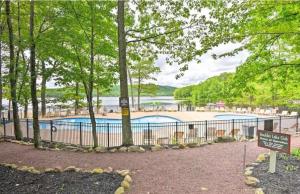 a fence with a swimming pool in a park at Lake Life Adventures 4 Bedroom Home in Lake Harmony