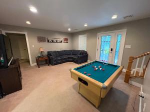 a living room with a pool table in it at Lake Life Adventures 4 Bedroom Home in Lake Harmony