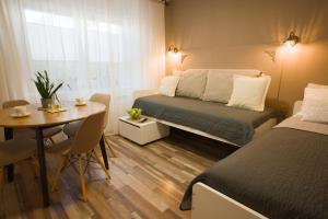 a small room with a bed and a table and a desk at FRIZ&FANY Charm House in Postojna