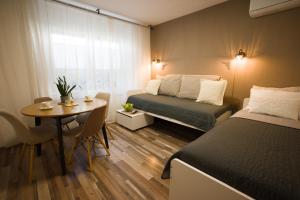 a small room with a bed and a table and a bed at FRIZ&FANY Charm House in Postojna